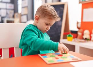 child with shape blocks