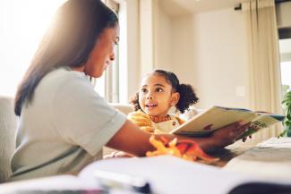 child and parent reading at home 